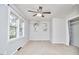 Bright bedroom features a ceiling fan, large windows, and carpet at 2616 Kirk Rd, Durham, NC 27705