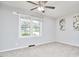 Neutral bedroom features a ceiling fan, large windows, and carpet at 2616 Kirk Rd, Durham, NC 27705