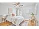 Cozy bedroom boasts hardwood floors, ceiling fan, large window, and neutral colors at 2616 Kirk Rd, Durham, NC 27705