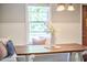Cozy breakfast nook boasts built-in bench seating, decorative pillows, and a rustic wooden table at 2616 Kirk Rd, Durham, NC 27705