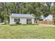 Well-maintained exterior with green grass and a small garden at 2616 Kirk Rd, Durham, NC 27705
