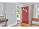 The Foyer boasts an open red door leading outside, and hardwood floors at 2616 Kirk Rd, Durham, NC 27705