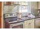 Well-lit kitchen features stainless steel appliances, mosaic backsplash, and black granite countertops at 2616 Kirk Rd, Durham, NC 27705