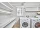 Bright laundry room features a washer, dryer, shelving and window at 2616 Kirk Rd, Durham, NC 27705