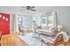 Inviting living room featuring a stylish sofa, chairs, ceiling fan, and plenty of natural light at 2616 Kirk Rd, Durham, NC 27705