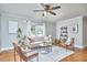 Bright living room with neutral colors, a ceiling fan, stylish furniture, and a patterned rug at 2616 Kirk Rd, Durham, NC 27705