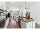 White gourmet kitchen boasts stainless appliances, a central island, and an adjacent dining area with plenty of sunlight at 2802 Kempthorne Rd # 64, Cary, NC 27519