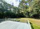Expansive deck with white railing overlooking a private, wooded backyard at 2934 Appaloosa Ct, Graham, NC 27253