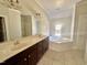 Bathroom featuring a double sink vanity and a large soaking tub at 2934 Appaloosa Ct, Graham, NC 27253