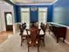 Elegant dining room with wainscoting, chandelier, and large wooden table at 2934 Appaloosa Ct, Graham, NC 27253