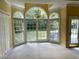 Bright sunroom with large windows providing views of the backyard and landscaping at 2934 Appaloosa Ct, Graham, NC 27253