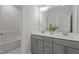 Double vanity bathroom featuring gray cabinets, neutral walls, and modern sinks at 3020 Mavisbank Cir, Apex, NC 27502
