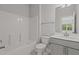 Bathroom featuring a shower-tub combo, gray vanity, and a white toilet at 3020 Mavisbank Cir, Apex, NC 27502