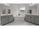 Bright bathroom with gray vanity, marble floors, soaking tub, and neighborhood view at 3020 Mavisbank Cir, Apex, NC 27502