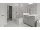 Elegant bathroom with marble shower, glass enclosure, and neutral vanity at 3020 Mavisbank Cir, Apex, NC 27502