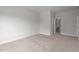 Bedroom with neutral walls and carpet and an ensuite bathroom through the doorway at 3020 Mavisbank Cir, Apex, NC 27502