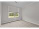 Bright bedroom with neutral carpet and view of wooded back yard at 3020 Mavisbank Cir, Apex, NC 27502
