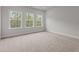 Bedroom with lots of natural light provided by the three windows, neutral walls, and carpet at 3020 Mavisbank Cir, Apex, NC 27502