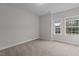 Bright bedroom with two windows and neutral colored carpet at 3020 Mavisbank Cir, Apex, NC 27502