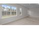 Bedroom with neutral walls, carpet, tray ceiling with recessed lighting, and three large windows at 3020 Mavisbank Cir, Apex, NC 27502