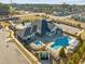 Aerial view of a community clubhouse with pools, a playground, and parking, set in a well-maintained neighborhood at 3020 Mavisbank Cir, Apex, NC 27502