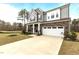 Beautiful two-story home with stone accents, gray siding, two-car garage, and well-maintained front yard at 3020 Mavisbank Cir, Apex, NC 27502