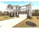 Beautiful two-story home featuring stone accents, gray siding, a two-car garage, and a meticulously kept lawn at 3020 Mavisbank Cir, Apex, NC 27502