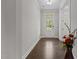 Inviting foyer with hardwood floors, white trim, and a front door that shows an open and airy space at 3020 Mavisbank Cir, Apex, NC 27502