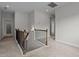 Upstairs hallway featuring carpet, wooden banister, and ample lighting at 3020 Mavisbank Cir, Apex, NC 27502