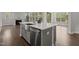 Kitchen island with a stainless steel sink, dishwasher, and white countertops in an open-concept layout at 3020 Mavisbank Cir, Apex, NC 27502