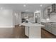 Kitchen island featuring a white countertop, gray cabinets, and stainless steel sink and appliances at 3020 Mavisbank Cir, Apex, NC 27502