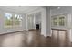 Spacious living room with hardwood floors, a modern fireplace, and plenty of natural light through large windows at 3020 Mavisbank Cir, Apex, NC 27502