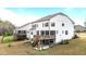 Rear exterior view with wooden deck and screened in porch, overlooking a well maintained lawn and trees at 3020 Mavisbank Cir, Apex, NC 27502