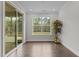 Bright sunroom with natural light, hardwood floors, sliding door to backyard and large windows at 3020 Mavisbank Cir, Apex, NC 27502