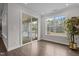Bright sunroom with hardwood floors, sliding door to backyard and large windows overlooking the landscape at 3020 Mavisbank Cir, Apex, NC 27502