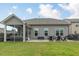 The backyard features a screened porch, patio with seating, and a well-maintained lawn perfect for outdoor gatherings at 304 Avery Glenn Way, Fuquay Varina, NC 27526