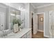 Elegant bathroom featuring dual sinks, stone countertops, and a glass-enclosed shower at 304 Avery Glenn Way, Fuquay Varina, NC 27526