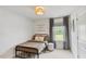 This bedroom features stylish wallpaper, a window with curtains, and a cozy bed for a relaxing atmosphere at 304 Avery Glenn Way, Fuquay Varina, NC 27526