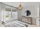 Cozy bedroom with plaid bedding, natural light, and dresser storage at 304 Avery Glenn Way, Fuquay Varina, NC 27526