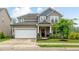 Charming two-story home featuring a two-car garage and a well-manicured lawn at 304 Avery Glenn Way, Fuquay Varina, NC 27526