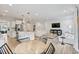 Open-concept living area with eat-in kitchen, stainless appliances, wood floors, and comfortable seating at 304 Avery Glenn Way, Fuquay Varina, NC 27526