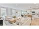 Bright, open living space featuring hardwood floors, lots of light, and stylish white sofas at 304 Avery Glenn Way, Fuquay Varina, NC 27526
