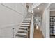 Elegant staircase featuring natural wood steps, white risers and railing and modern design at 304 Avery Glenn Way, Fuquay Varina, NC 27526