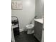 Cozy bathroom with black hexagon tile, gray vanity, and decorative wall art at 305 Briarcliff Dr, Dunn, NC 28334