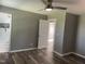 Bedroom with wood-look floors and a view of a tiled bathroom and closet at 305 Briarcliff Dr, Dunn, NC 28334