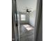 Bright bedroom with wood-look flooring, ceiling fan, and a window at 305 Briarcliff Dr, Dunn, NC 28334