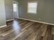 Bedroom featuring wood-look floors, light gray walls, and natural light at 305 Briarcliff Dr, Dunn, NC 28334