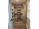 Walk-in closet with wood-look floors and adjustable shelving at 305 Briarcliff Dr, Dunn, NC 28334