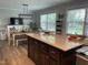 Open kitchen with large island and adjacent dining area with decorative lighting at 305 Briarcliff Dr, Dunn, NC 28334