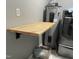 Laundry area features a wood folding table, gray water heater, and gray washing machine at 305 Briarcliff Dr, Dunn, NC 28334